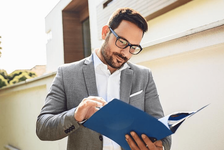 A new real estate agent reviewing property listings, answering “Is real estate a good job?”