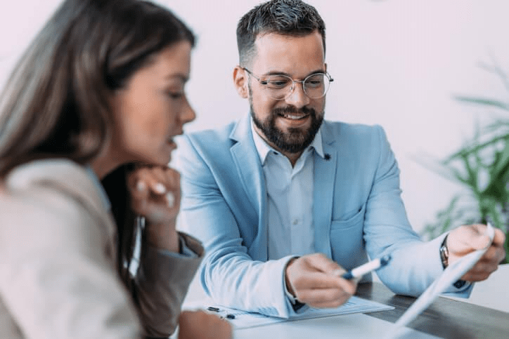 A real estate broker discussing contracts with a colleague